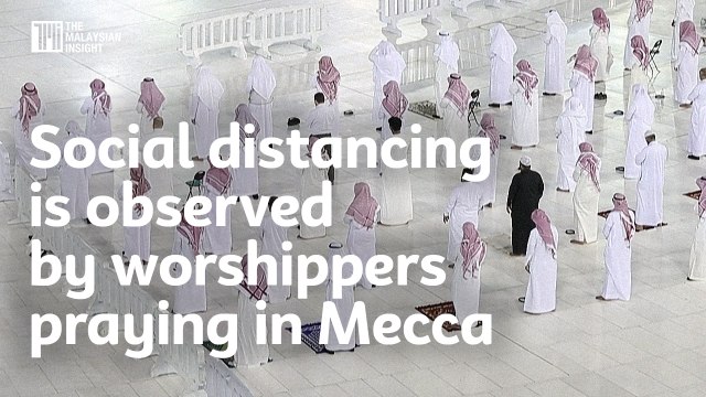 Social distancing is observed by worshippers praying in Mecca