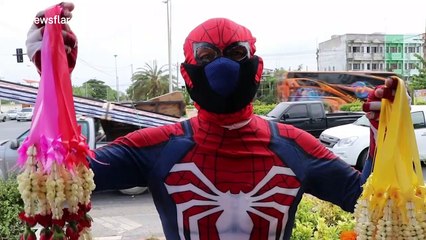 Thai man dresses up as Spider-Man to sell flowers to motorists during coronavirus pandemic