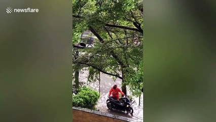 Tropical downpour causes flash flooding on roads in Bangkok, Thailand