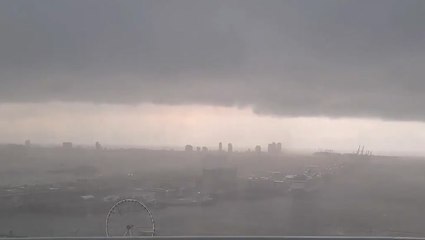 City disappears into wall of rain
