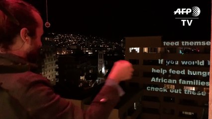 Cape Town residents use projector to promote charities during lockdown