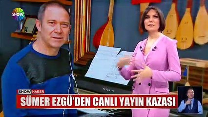 Download Video: Sümer Ezgü, canlı yayında tabureden düştü