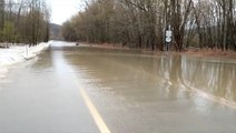 Overflowing river floods road