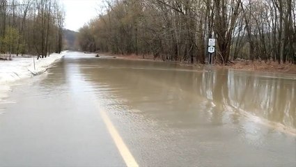 Overflowing river floods road