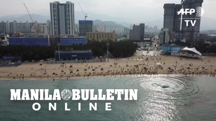 Crowds pack Seoul beach as new virus cases drop
