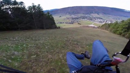 Daredevil paraglides only inches from the ground in French mountains