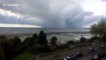 Timelapse shows dark rain clouds drift over the Thames estuary