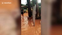 Dozens of homes damaged by muddy torrents during flash floods in northern Thailand