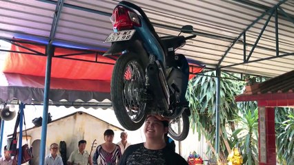 Dancing Lady Balances Bike on Her Head