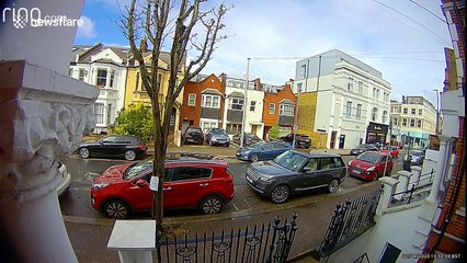 Bizarre moment delivery driver SPITS on railings and lamp posts in London