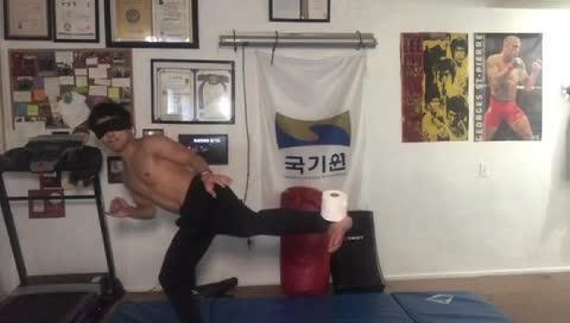 Blindfolded martial arts master slams down a sledgehammer inches
