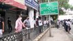 Indian police attempt to control large crowds queuing to enter liquor stores