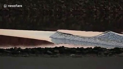 UK photographer captures rare tidal bore phenomenon funnelling along river