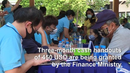 Thousands queue for government aid in Thailand as pandemic destroys the economy