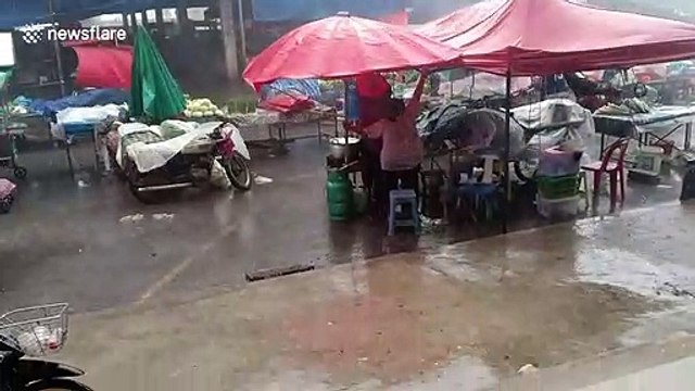 Tropical storm batters market in northern Thailand as temperatures hit 40C