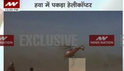 Crazy! Man takes a hanging ride in helicopter