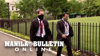 White House staffers walk to work wearing face masks