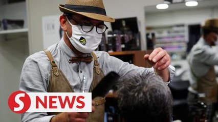 Midnight haircuts: France wastes no time getting back to work