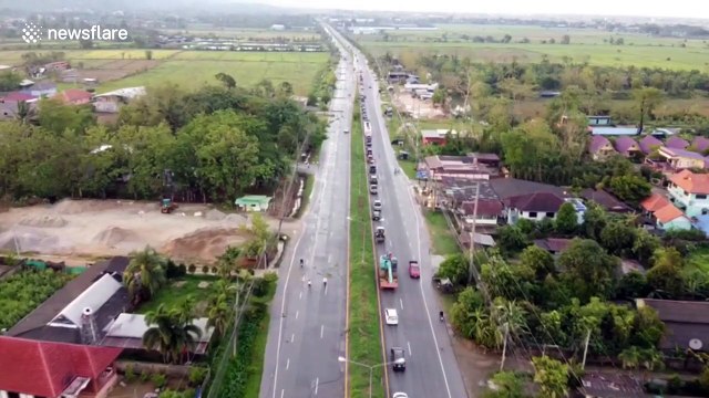 Driver injured after tropical storm pulls electricity lines onto cars in Thailand