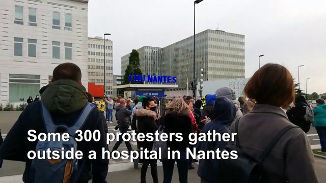 Hundreds protest outside French hospital over virus response