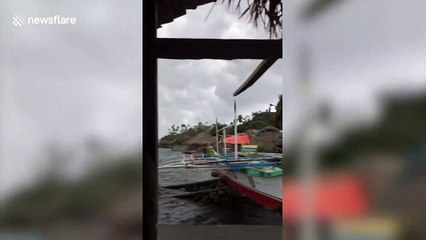 Fishermen rush back to shore as Typhoon Ambo makes landfall in the Philippines