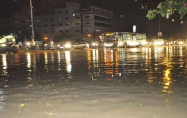 Rain lashes parts of Hyderabad; people using boats for transport.