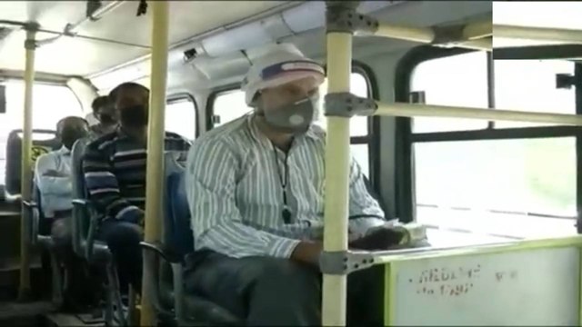 DTC buses ply on roads, people maintain social distancing