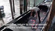 Venice gondolas are back on the canals, waiting for tourists
