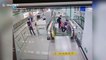 Chinese policeman hops over glass railing to stop escalator after elderly woman falls over on it