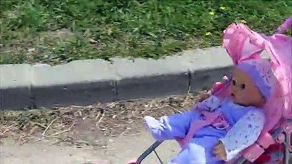 Toy baby doll outing to playground going for walk sitting on the swing sliding down slide