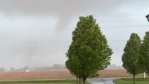 Powerful tornado spins through field