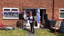 Singer Ann Critchlow performing for residents on Rubens Avenue