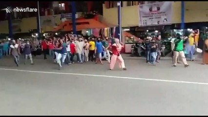 Angry market traders tear down coronavirus road block in Indonesia