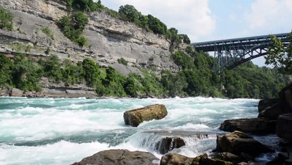 River flowing between mountain and bridge showing natural beauty