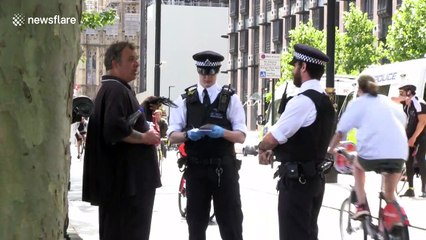 People argue with police over COVID-19 laws outside New Scotland Yard in London