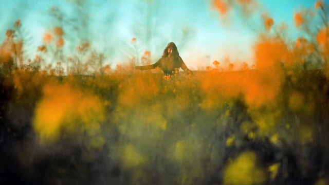 Woman Dancing Happily In The Middle Of The Field Of Flowers