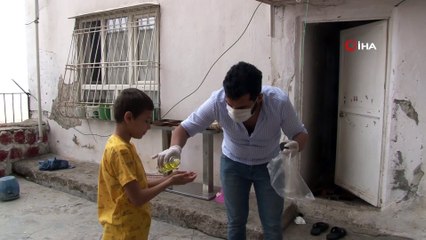 Sokağa çıkamayan çocuklar şekerlerini sepet sarkıtarak aldı