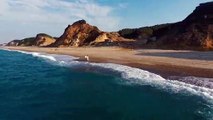 Drone view - couple on beach shore