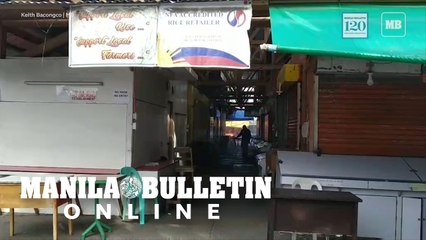 A personnel of the City Health Office sprays disinfectant inside Agdao Market
