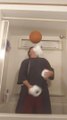 Man Spins Basketball Over Pencil Held in Mouth While Juggling Toilet Paper Rolls