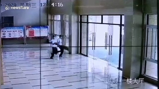 Firefighter in China runs straight into glass door while rushing away to emergency