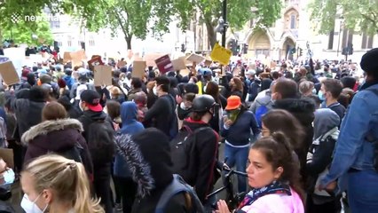 Black Lives Matter protesters clap in unison at Parliament Square