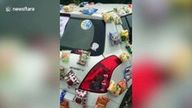 Kind couple hand out snacks stuck to their 'community pantry' car during COVID-19 pandemic