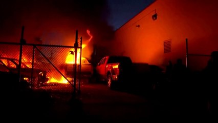 Fires burn into the night in Minneapolis, as former officer charged in George Floyd murder