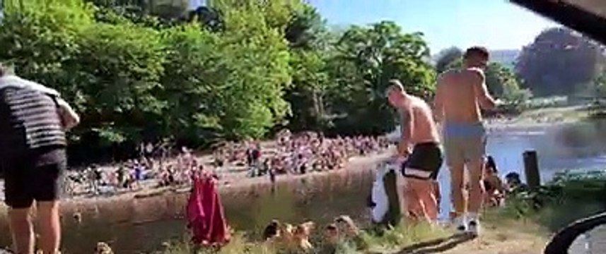 Large groups of people by Ilkley river during UK lockown