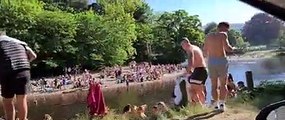 Large groups of people by Ilkley river during UK lockown