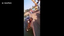 Crane plummets into river after attempting to rescue sinking vehicle in India