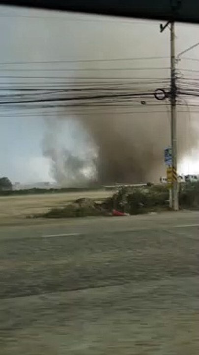 Terrifying moment mini tornado blows over concrete posts and huts during storms in Thailand
