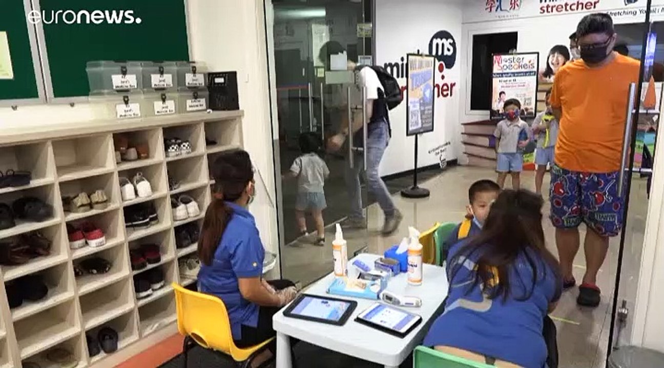 Pupils wearing face masks return to school in Singapore