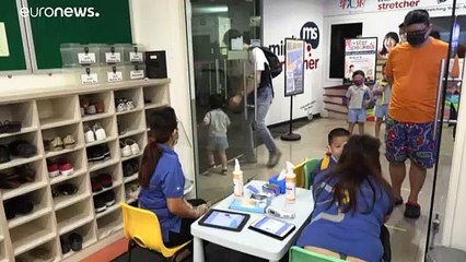 Pupils wearing face masks return to school in Singapore